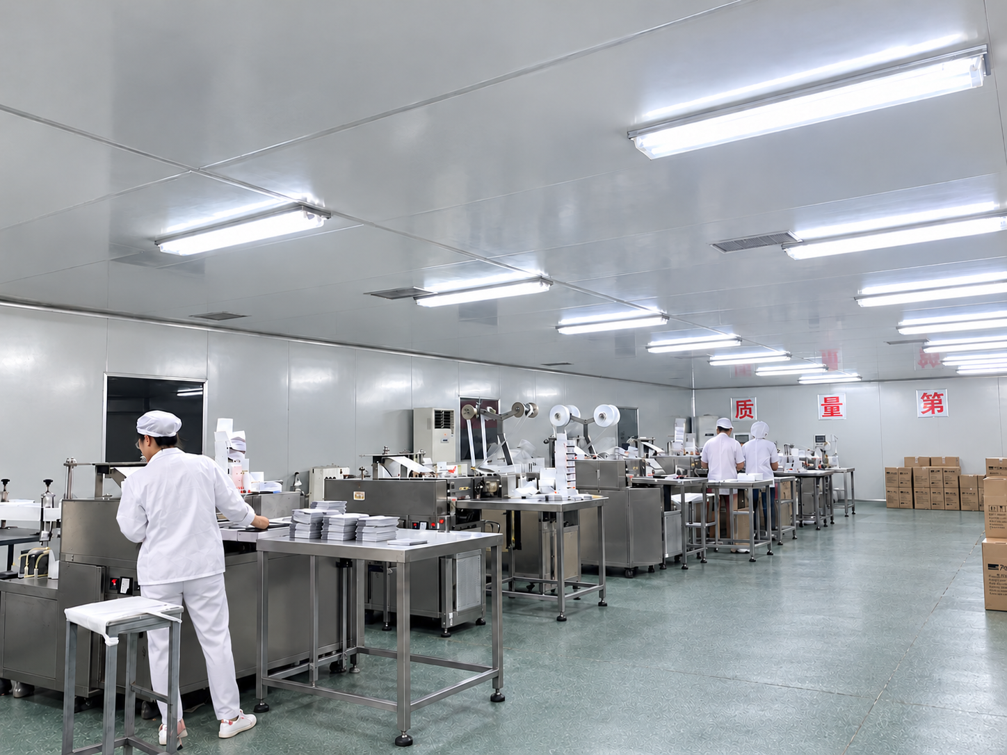 Wide view of Kangyou workshop, operators in white workwear and production lines